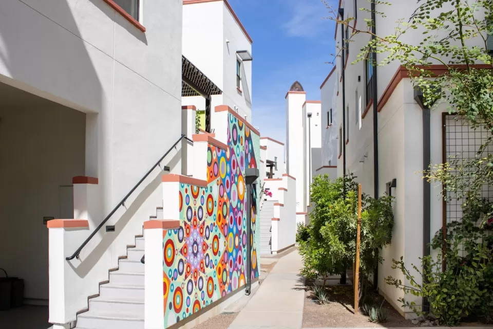 Colorful two-story buildings close to each other in Culdesac Tempe development.